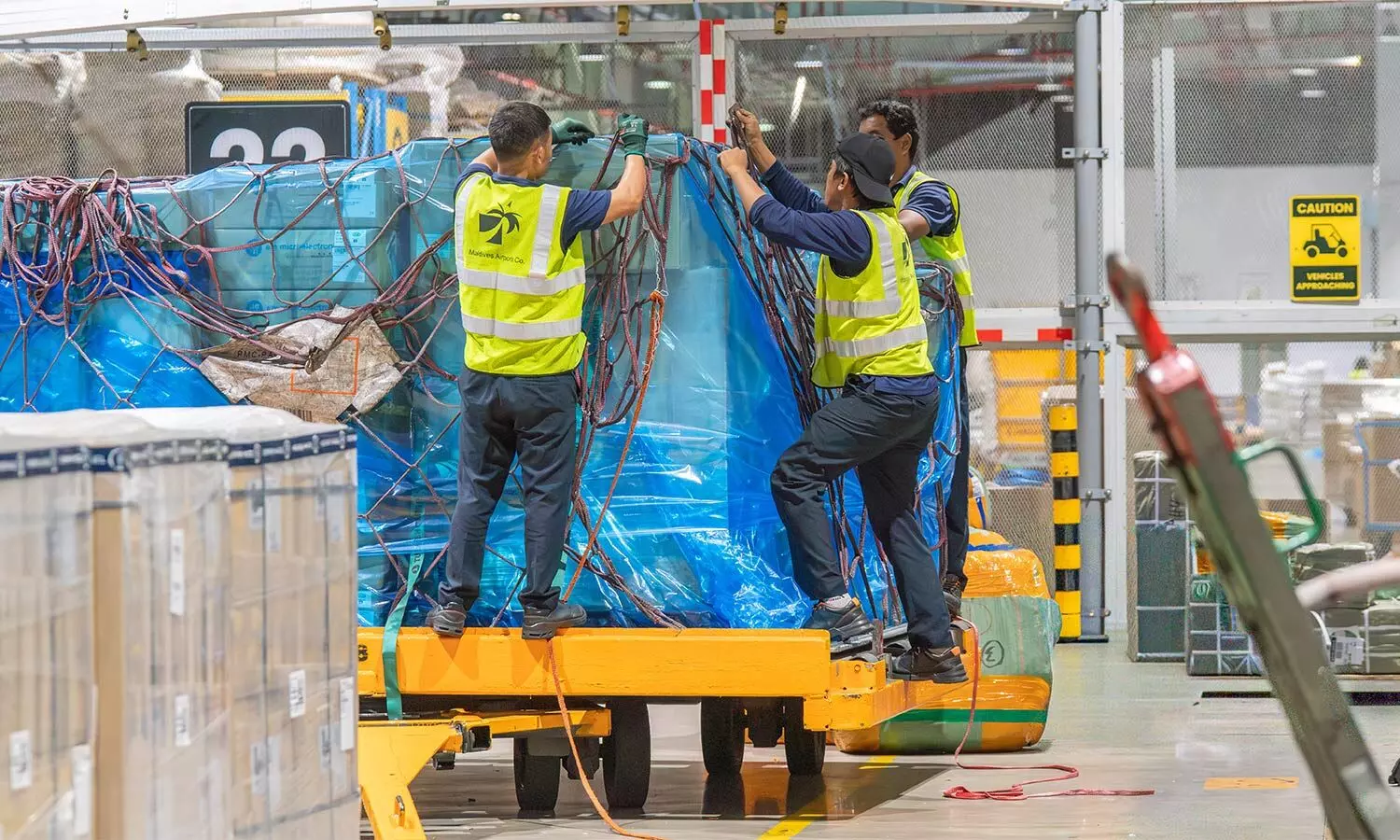 Ground handlers secure a shipment on the ramp at Velana International Airport https://www.stattimes.com/air-cargo/air-cargos-empty-half-the-problem-more-freighters-cant-fix-1360476