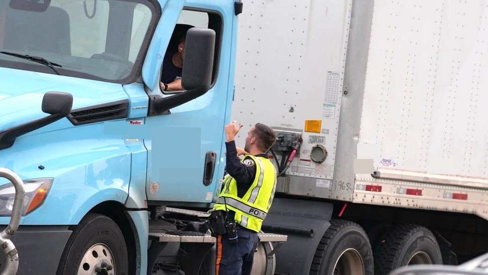 Piscataway Township police officer speaking with a commercial truck driver